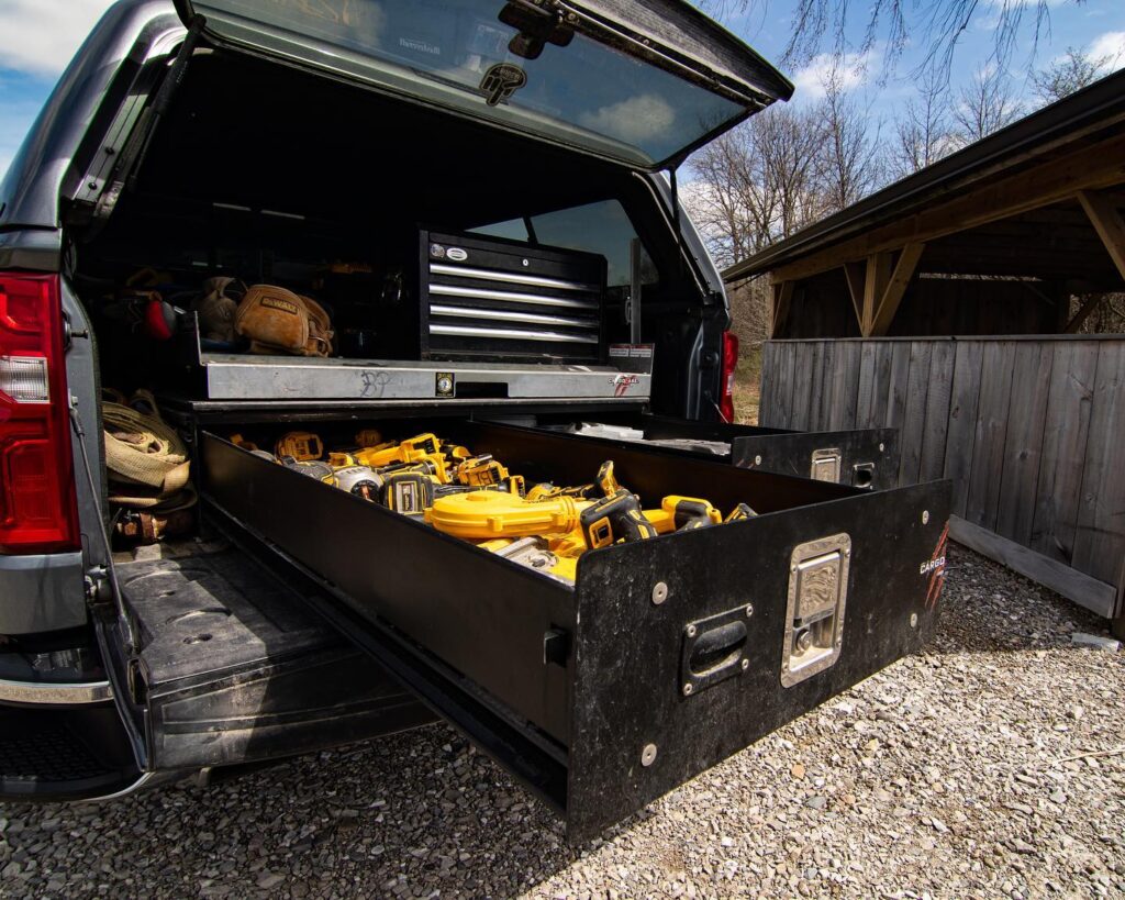 Cargo Ease Base Locker with Hybrid Truck Slide installed in a pickup truck for organized contractor tool storage and cargo access