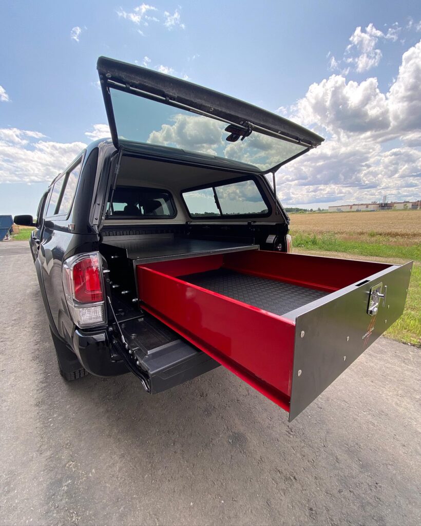 Cargo Ease Mighty Series locker extended from a pickup truck bed for heavy-duty drawer storage and equipment access