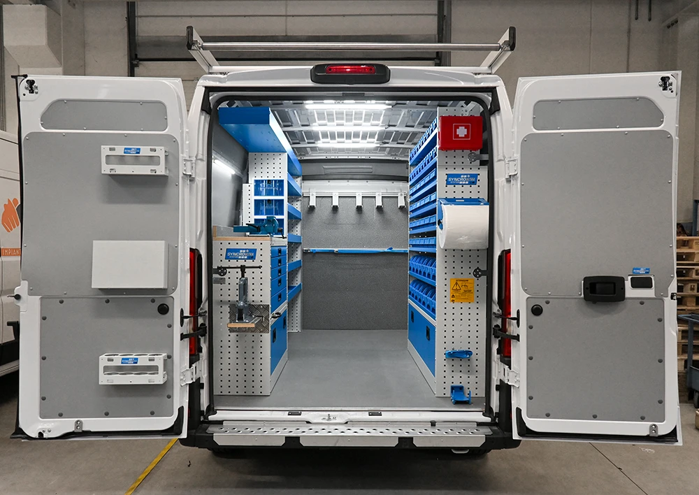 Rear view of RAM ProMaster 159-inch high-roof plumber van shelving with drawers, parts bins, and clear aisle