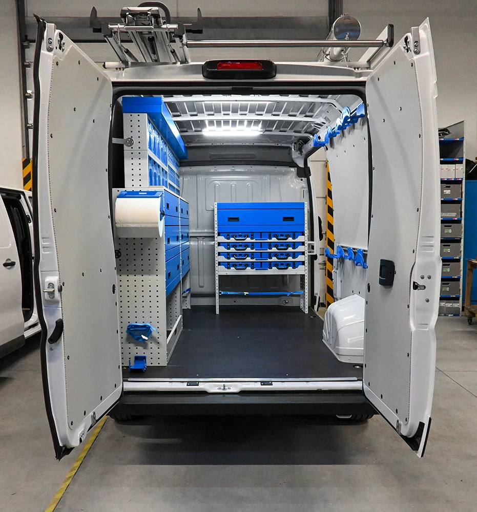 Rear view of RAM ProMaster 159-inch low-roof electrician van shelving with drawers, parts bins, and wall holders