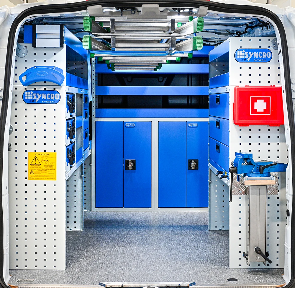 Rear view of full-size regular-wheelbase electrician van shelving with dual-side storage, overhead ladder rack, and front cabinets