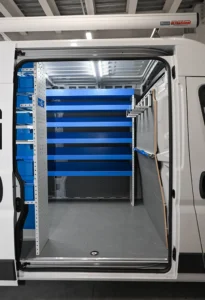 Side-door view of RAM ProMaster plumber van shelving with wide open shelves and clear cargo-floor space