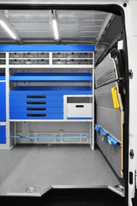 Side-door view of Mercedes-Benz Sprinter electrician van shelving with open shelves, drawers, and removable case