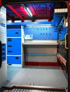 Side-door mobile mechanic van workstation with drawers, work surface, tool panel, and overhead shelving
