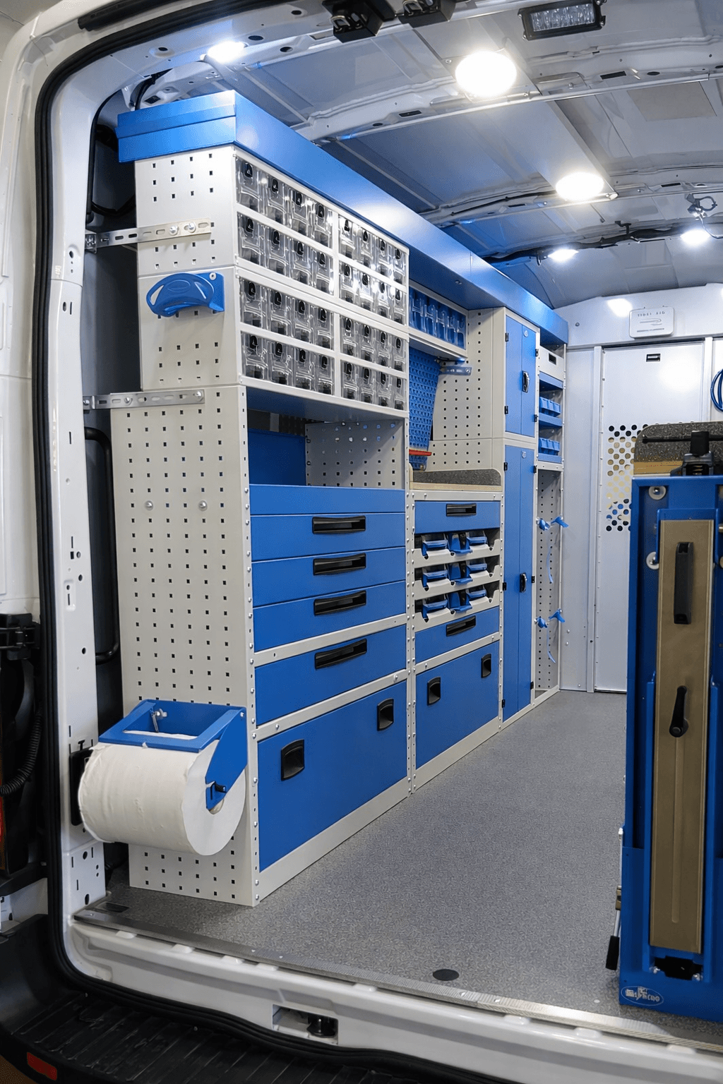 Organized trade service van interior with van shelving, drawers, storage bins, and tool storage