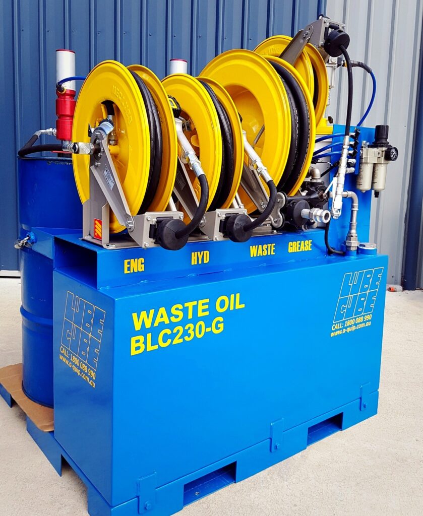 MecLube equipment set up on a Blue Lube Cube, lube skid with yellow hose reels, hydraulic connections, and labeled service points for engine, hydraulic, waste, and grease fluids