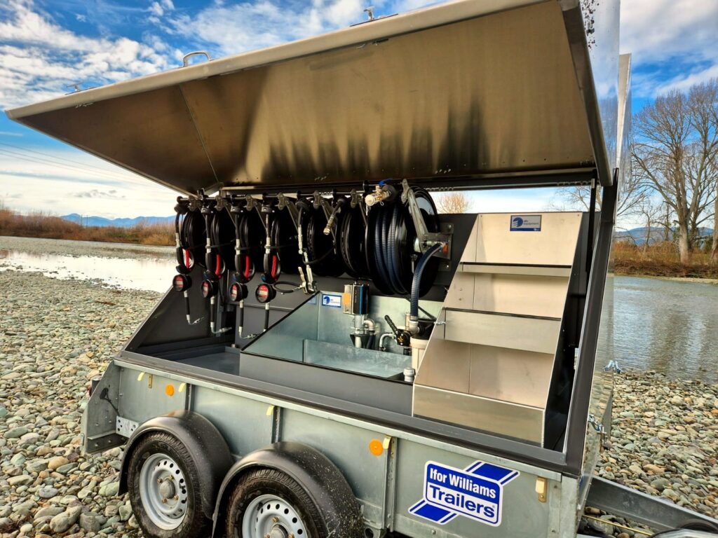 MecLube equipment Close-up of open lube trailer showing hose reels, meters, tanks, and organized fluid dispensing compartments.