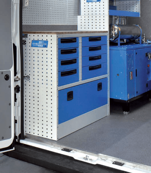 Syncro van shelving and drawers positioned around large equipment inside a mobile service van