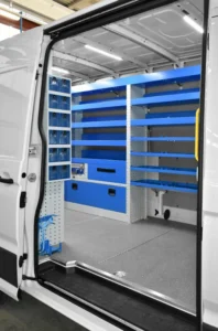 Side-door view of Sprinter plumber van shelving with wide open shelves, drawers, and lower storage